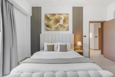 a bedroom with a large white bed with pillows at Act One Luxury 2BR Front-Row Burj & Fountain Views in Dubai