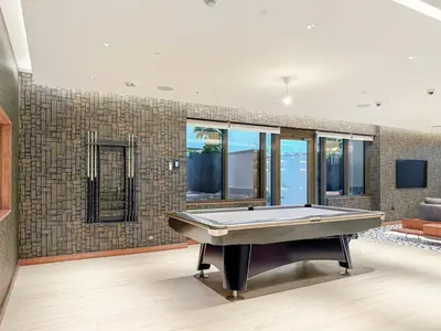 a living room with a pool table in it at FIRST CLASS 2BR Bright and Elegant Living in Dubai