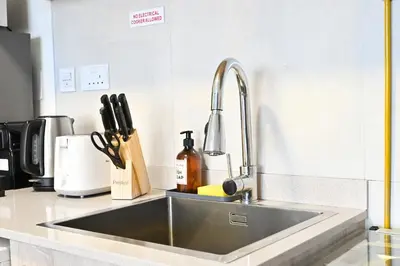 a stainless steel sink in a kitchen with a counter at Sylish Studio with Balcony Views Near Dubai Mall in Dubai