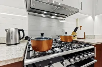 two pots sitting on top of a stove in a kitchen at FIRST CLASS 2BR Luxury Living in Downtown in Dubai