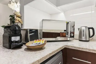 a kitchen counter with a coffee maker and a microwave at FIRST CLASS 2BR Luxury Living in Downtown in Dubai