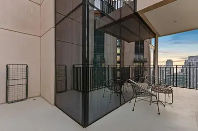 a balcony with chairs and tables on a building at FIRST CLASS 2BR Luxury Living in Downtown in Dubai