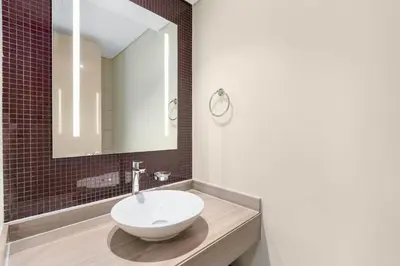 a bathroom with a sink and a mirror at Your Hollywood-Style Hideaway -DAMAC Paramount in Dubai