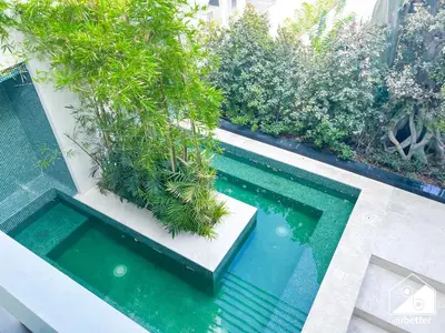 an overhead view of a swimming pool with plants at Luxury 1BR Escape, Resort-Style Living in Dubai in Dubai