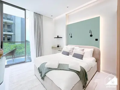 a bedroom with a large bed and a large window at Luxury 1BR Escape, Resort-Style Living in Dubai in Dubai