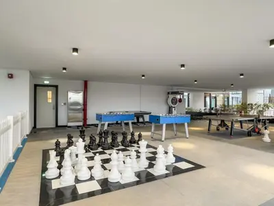 a large room with a chessboard and tables at FIRST CLASS 2BR Chic Getaway Close to Metro in Dubai