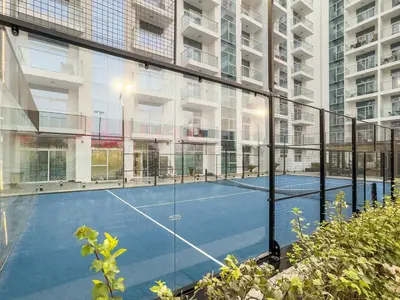 a tennis court in the middle of a building at FIRST CLASS 2BR Chic Getaway Close to Metro in Dubai