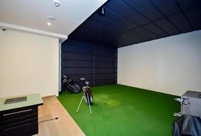 a room with a room with a green floor and a room with a room at Modern 1BR with city views large space in Dubai
