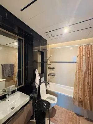 a bathroom with a sink and a toilet and a tub at Modern 1BR with city views large space in Dubai