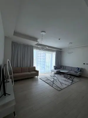 a living room with a couch and a table at Modern 1BR with city views large space in Dubai