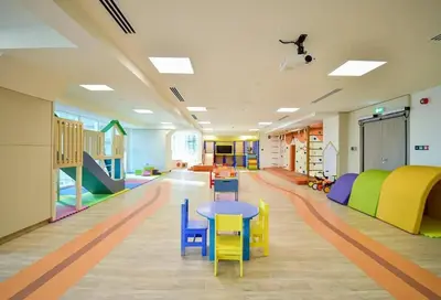 a classroom with a table and chairs in a room at Modern 1BR with city views large space in Dubai