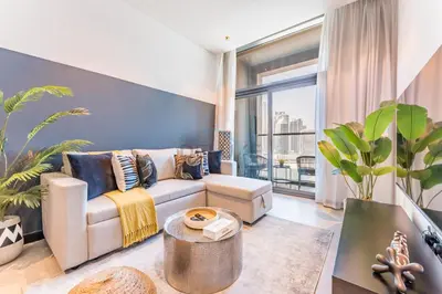 a living room with a couch and a large window at Burj Khalifa and Dubai Canal Views, Minutes from Downtown Dubai, Convenient Metro Access - 15 Northside Tower 2, Business Bay by Deluxe Holiday Homes in Dubai