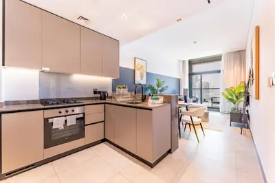a kitchen with white cabinets and a counter top at Burj Khalifa and Dubai Canal Views, Minutes from Downtown Dubai, Convenient Metro Access - 15 Northside Tower 2, Business Bay by Deluxe Holiday Homes in Dubai