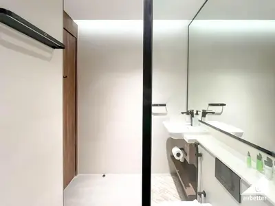 a bathroom with two sinks and a mirror at Spacious 1-BR with Balcony & Leisure Facilities in Dubai