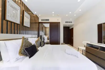 a bedroom with a large white bed with pillows at FAM Living Elite Residence 1BR Walk to JBR Beach in Dubai