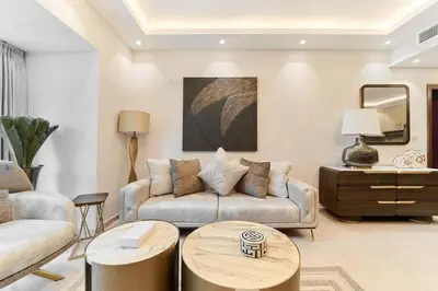 a living room with a couch and a table at FAM Living Elite Residence 1BR Walk to JBR Beach in Dubai
