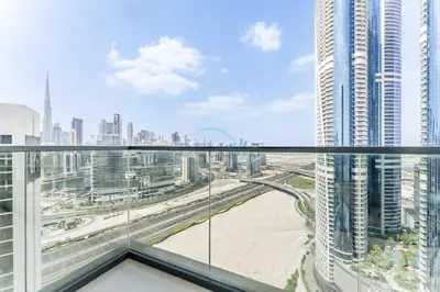 a view of a city from the balcony of a skyscraper at Spacious High-Floor 2BR with Stunning City and Burj Khalifa Views, Quick Drive to Downtown, and Steps from the Bus Station, Nobles, Business Bay by Deluxe Holiday Homes in Dubai