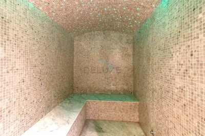 a corner of a room with a brick wall at Spacious High-Floor 2BR with Stunning City and Burj Khalifa Views, Quick Drive to Downtown, and Steps from the Bus Station, Nobles, Business Bay by Deluxe Holiday Homes in Dubai