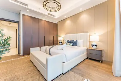 a white bedroom with a large bed and a couch at Spacious High-Floor 2BR with Stunning City and Burj Khalifa Views, Quick Drive to Downtown, and Steps from the Bus Station, Nobles, Business Bay by Deluxe Holiday Homes in Dubai
