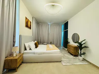 a bedroom with a bed and a large window at Stylish One Bed Apartment near Downtown in Dubai