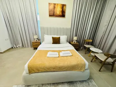 a bedroom with a large bed with two towels on it at Stylish One Bed Apartment near Downtown in Dubai