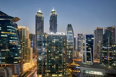 a city skyline at night with tall buildings at Stylish 1BR Apartment, ZADA Tower with Pool & Gym, Business Bay in Dubai