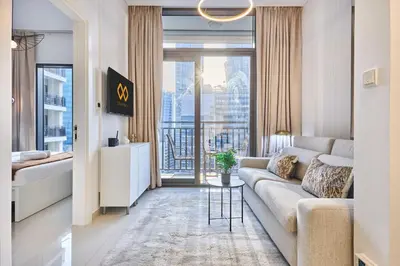 a living room with a couch and a large window at Stylish 1BR Apartment, ZADA Tower with Pool & Gym, Business Bay in Dubai