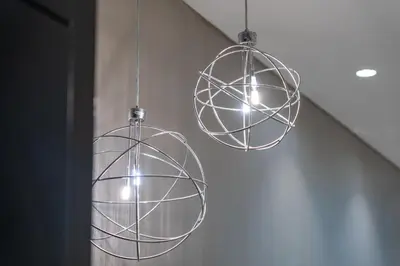 two metal spheres hanging from a ceiling at DAMAC MAISON DISTINCTION - Burj Khalifa View, Fee Parking in Dubai