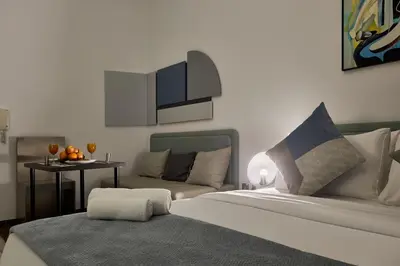 a living room with a bed and a couch at New Studio Apartment, MAG 910 - Dubai Stay in Dubai