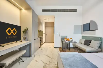 a hotel room with a couch and a table at New Studio Apartment, MAG 910 - Dubai Stay in Dubai
