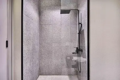 a bathroom with a glass shower with a toilet at New Studio Apartment, MAG 910 - Dubai Stay in Dubai