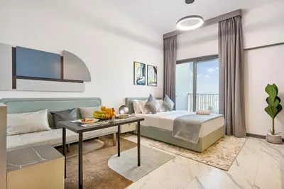 a living room with a bed and a couch at New Studio Apartment, MAG 910 - Dubai Stay in Dubai