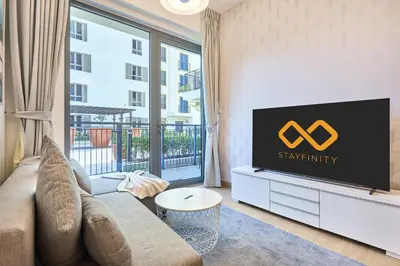 a living room with a couch and a flat screen tv at Le Pont Apartment in Port de La Mer with Pool Access, Retreat near the Beach in Dubai