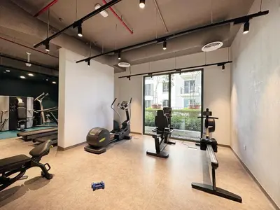 a gym with treadmills and exercise equipment in a room at Le Pont Apartment in Port de La Mer with Pool Access, Retreat near the Beach in Dubai