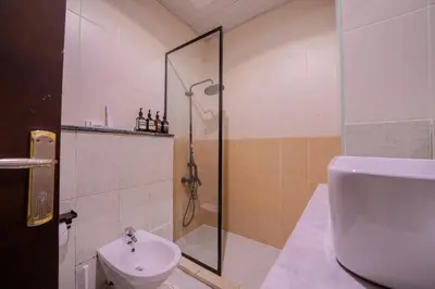 a bathroom with a shower and a toilet and a sink at Metrofront Stay - Walk to Iconic Dubai Spots in Dubai