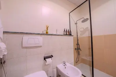 a bathroom with a shower and a toilet and a sink at Metrofront Stay - Walk to Iconic Dubai Spots in Dubai