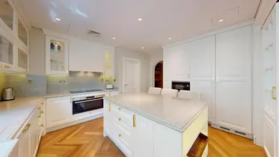 a kitchen with white cabinets and a counter top at Vacationer l Family Villa with Private Pool, Private Garden in Dubai