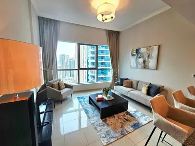 a living room with a couch and a table at SUNRISE HOMES - Stunning 1BR Marina View near Beach walk in Dubai