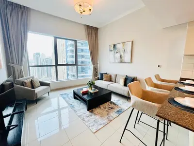a living room with a couch and a table at SUNRISE HOMES - Stunning 1BR Marina View near Beach walk in Dubai