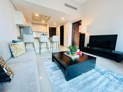 a living room with a couch and a coffee table at SUNRISE HOMES - Stunning 1BR Marina View near Beach walk in Dubai