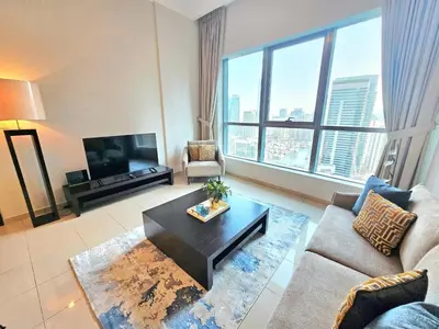 a living room with a couch and a coffee table at SUNRISE HOMES - Stunning 1BR Marina View near Beach walk in Dubai