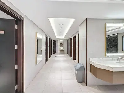 a hallway of a bathroom with two sinks and a mirror at Stylish Studio in Elite Downtown in Dubai