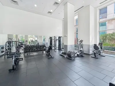 a large gym with cardio equipment in a building at Luxury 1BR with Workspace Next To Dubai Mall in Dubai