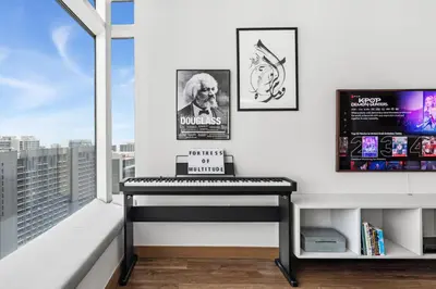 a living room with a piano and a large window at Luxury 1BR with Workspace Next To Dubai Mall in Dubai
