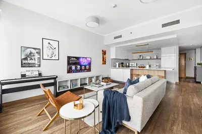 a living room with a couch and a piano at Luxury 1BR with Workspace Next To Dubai Mall in Dubai
