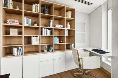 an office with a desk and bookshelves at Luxury 1BR with Workspace Next To Dubai Mall in Dubai