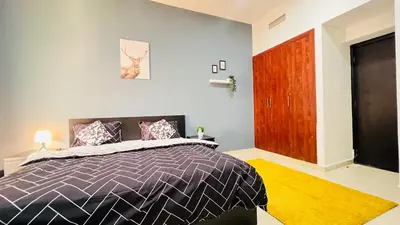 a bedroom with a bed and a wooden door at Marina View Retreat 1BR In Escan Tower Marina in Dubai