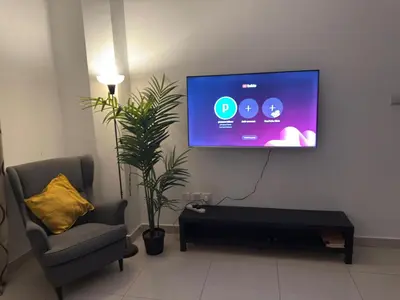 a living room with a tv on a wall at Marina View Retreat 1BR In Escan Tower Marina in Dubai
