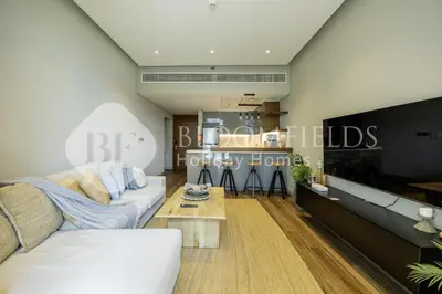 a living room with a couch and a table at Bloomfields Marquis 2020 in Arjan in Dubai
