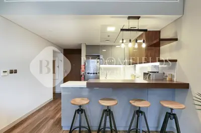 a kitchen with three stools at a counter at Bloomfields Marquis 2020 in Arjan in Dubai